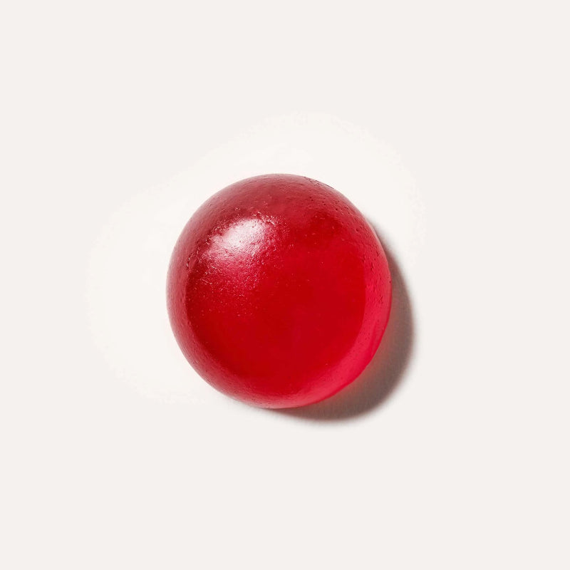 Red jelly bean on a white background